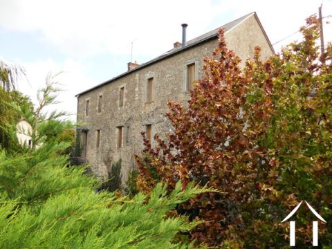 A working mill for a good part of its life, this impressive property is built of local hard stone and has a classic ardoise slate roof. It is sous sol to part of the rear of the property and has three floors of accommodation. Access is to both the front (onto the village road) and to the rear, via a driveway leading down from a small lane into the back courtyard and garden.