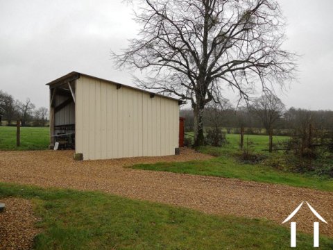 A small open hangar provides garaging space. This outbuilding could easily have doors fitted to provide a secure storage area.