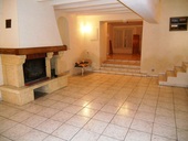 The lounge with its large fireplace (with wood burner). The three steps up lead to a mezzanine bedroom with a large family bathroom. The staircase on the right of the picture accesses the First Floor (large mezzanine and separate bedroom).