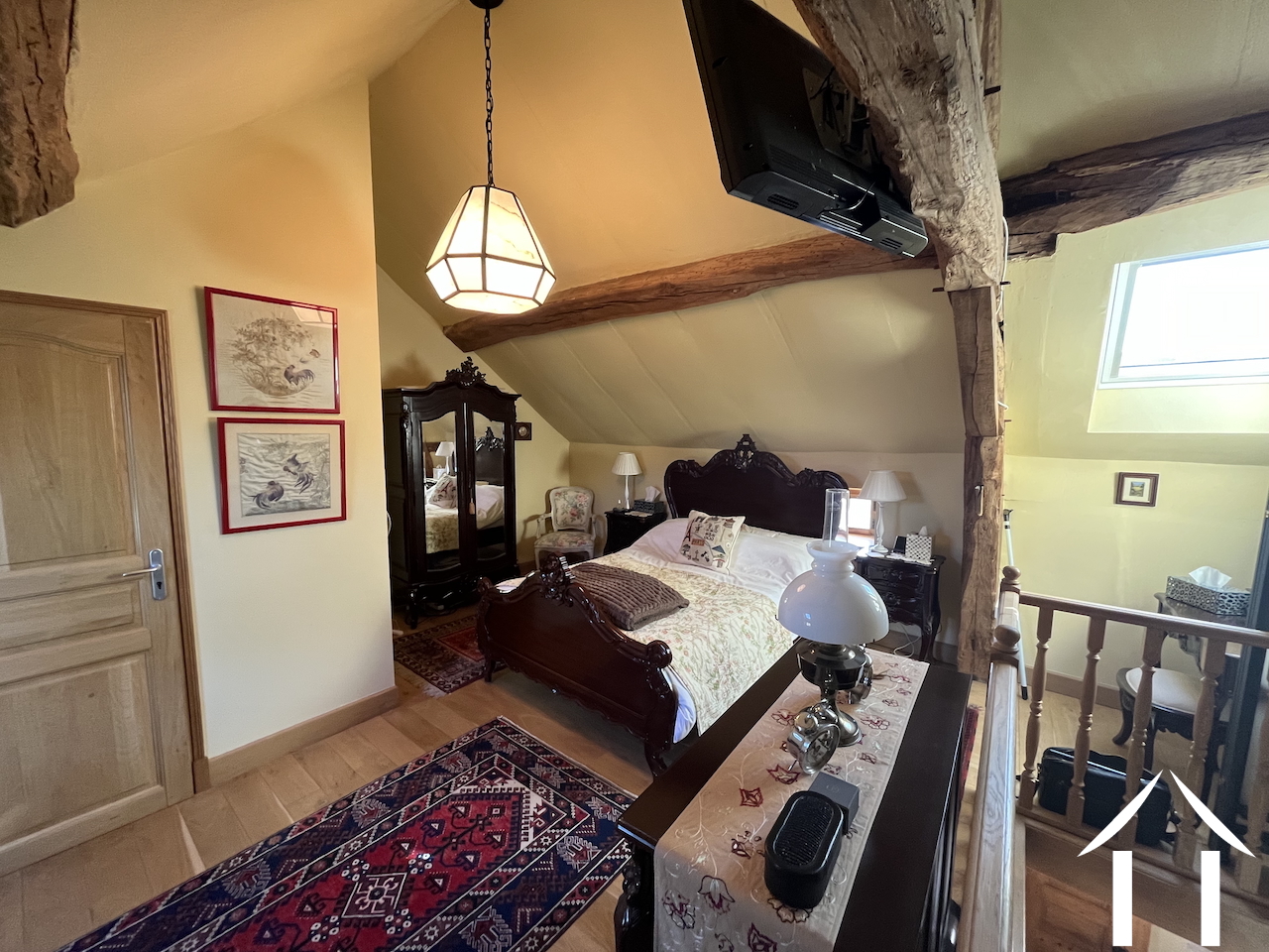 bedroom in open space of first floor, with en suite shower room next to it.