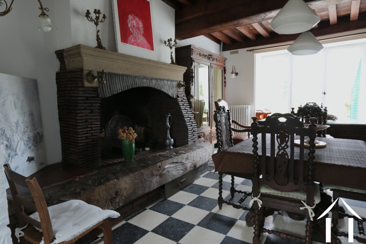 Huis 1: Woonkamer met open haard en grote Franse deuren