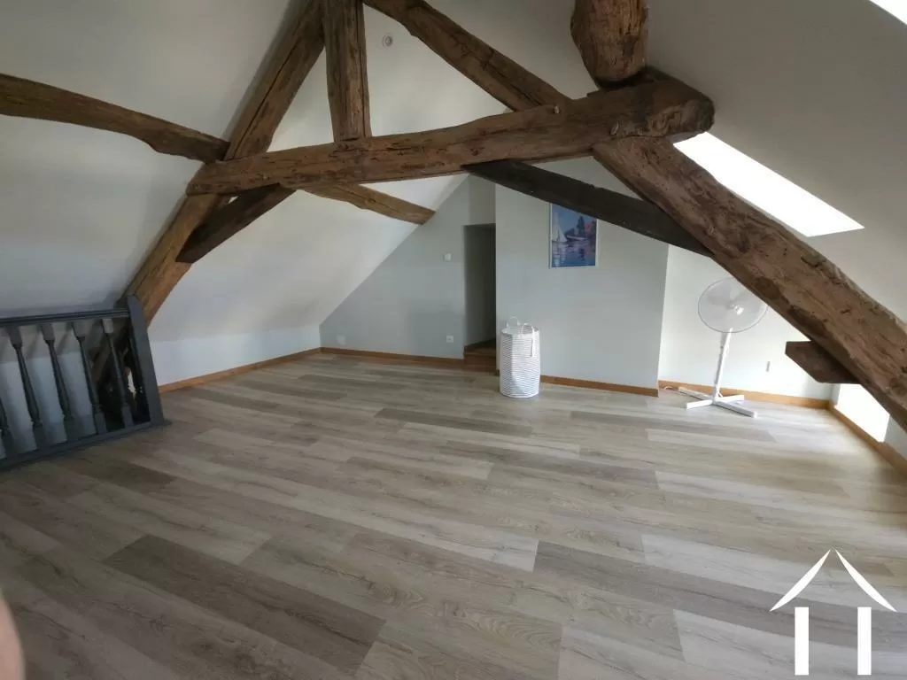 3rd floor room with exposed beams. You decide what it is used for. 