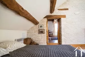 bedroom with exposed stone walls