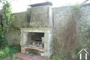 Stone fireplace/grill in courtyard