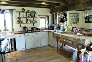 kitchen with dining area behind